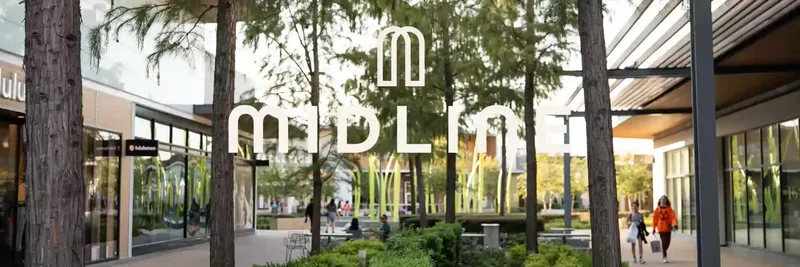 The Midline logo over a tree-lined outdoor shopping promenade