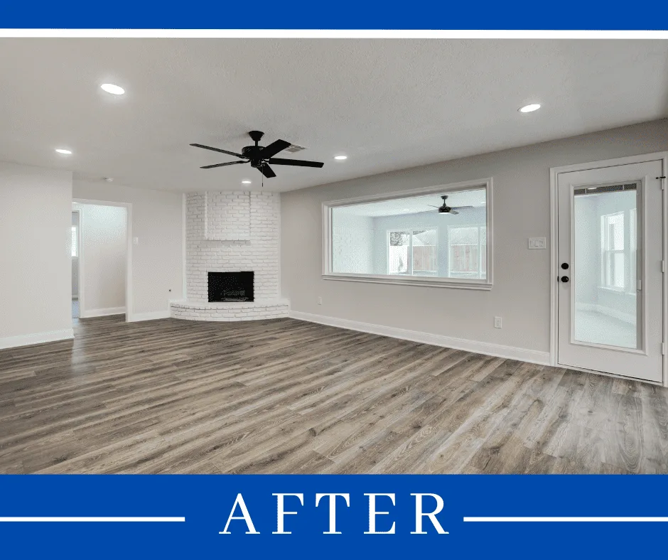 The renovated living room with new flooring and a corner fireplace (photo 6 of 7)