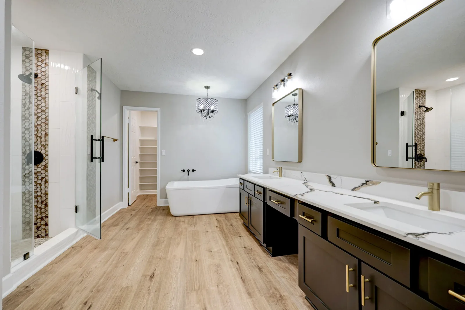 The remodeled primary bathroom: freestanding tub, walk-in shower and a double vanity (photo 1 of 4)